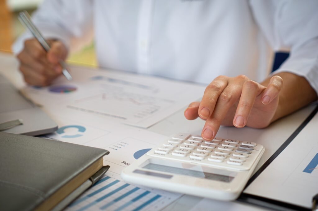Finance female staff members are using notebooks to print wholesale emails for sales leaders. On the