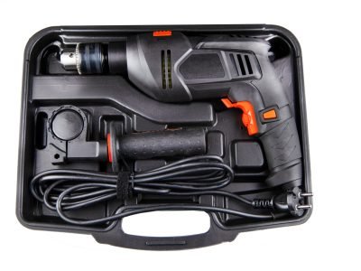 Electric drill in a suitcase. Keyless chuck. Gear teeth. Close-up tool. Metal details. Worker